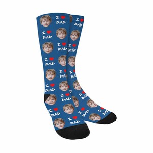 May include: A pair of blue socks with a repeated pattern of a child's face and the text "I love Dad" with a red heart.
