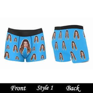 May include: Blue boxer shorts with a repeating pattern of a woman's face. The front of the boxer shorts has a black waistband. The back of the boxer shorts has a black waistband. The boxer shorts are shown on a white background. Style 1. Front. Back.