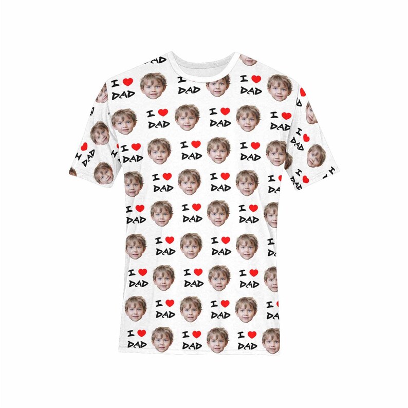 May include: White t-shirt with a repeating pattern of a child's face and the text "I love Dad" in black with a red heart.