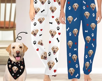 May include: Two pairs of pajama pants with a dog face pattern. The pants are white with red hearts and black paw prints on one pair and blue with red hearts and white paw prints on the other pair. The dog faces are different on each pair of pants. The text "30+ Color Available" is at the bottom of the image.
