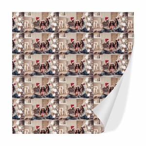 May include: A repeating pattern of a family of three opening Christmas presents in front of a decorated Christmas tree. The family are wearing Santa hats and smiling.