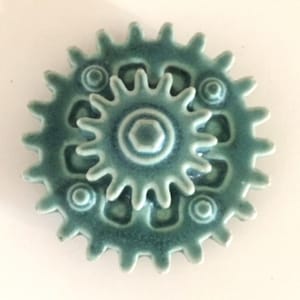 Michigan gallery Architectural pottery cog gear design iridescent green glaze