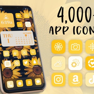 以下が含まれることがあります： 黄色のスマートフォン画面に、黄色と白のカラーテーマでカスタマイズされたアプリアイコンのデザインが表示されています。画面には、日付が「THU 1」、月が「OCTOBER」の予定表が表示されています。電話の上には、「4,000+ APP ICONS」というテキストが表示されています。