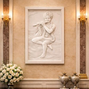 May include: A white relief sculpture of a seated figure playing a flute, framed in white. The sculpture is mounted on a textured wall. A bouquet of white roses in a silver vase and two decorative urns sit on a dark wood table.