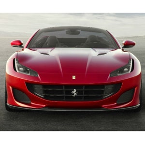 May include: A red Ferrari sports car with a black grille and a black front bumper. The car has a black interior and a black windshield.
