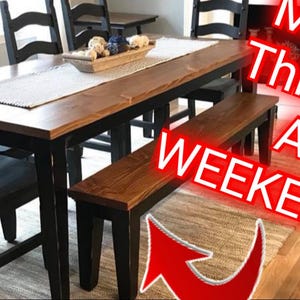May include: A wooden dining table with black chairs and a matching bench. The table has a natural wood finish and the chairs and bench are painted black. The text "Make This In A Weekend!" is superimposed on the image.