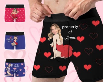 May include: Black boxer shorts with a red heart pattern and a woman's face in a red dress. The text "property of Anna" is printed on the shorts.