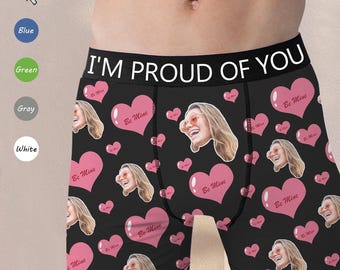 May include: Black boxer briefs with a pink and white heart pattern and the text "I'M PROUD OF YOU". The hearts have the words "Be Mine" written inside.