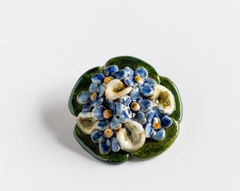 Ceramic brooch with little blue flowers
