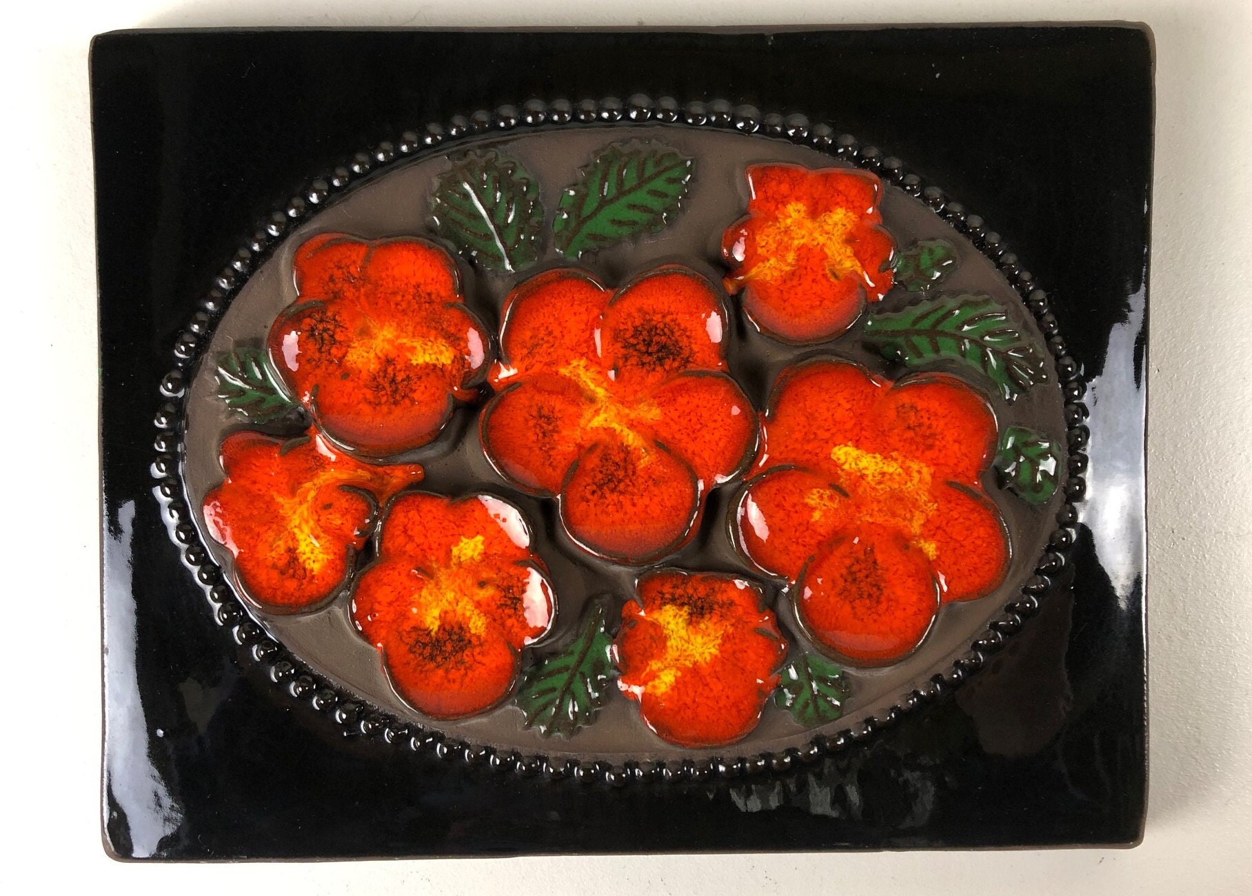 Jie Gantofta ceramic wall plaque with an orange with yellow flower motif, design Aimo Nietosvuori Sweden 1960s