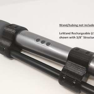 May include: A black 3D-printed accessory for a LeWand Rechargeable (LW-001) wand, shown with 3/8" structural tubing. The wand is silver with control buttons. The text "AND" is visible on the wand. The text "Wand/tubing not included" is also visible.