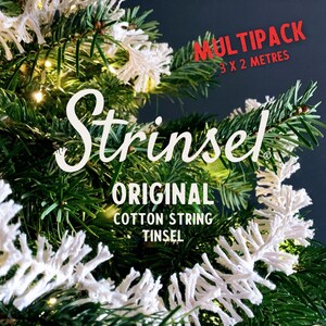 May include: White cotton string tinsel garland on a Christmas tree. The garland is labelled "Stringsel Original Cotton String Tinsel" and "Multipack 3 x 2 Metres".