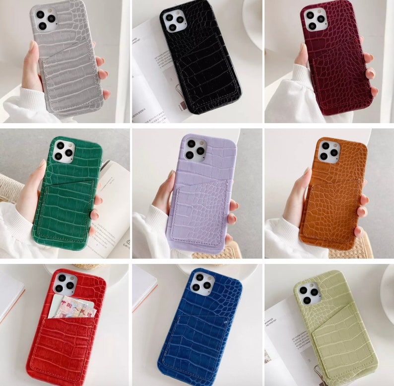 May include: Nine different colored phone cases with a crocodile pattern and a pocket on the back. The cases are in the colors: gray, black, red, green, purple, brown, red, blue, and green.