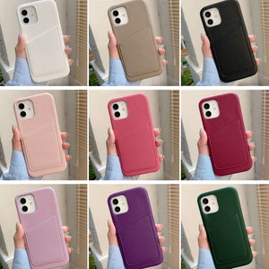 May include: Ten different colored phone cases with a card slot. The cases are made of a textured material and have a variety of colors, including black, white, pink, red, green, purple, and brown.
