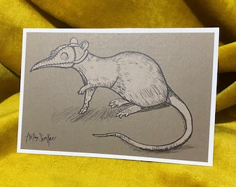 May include: A pen and ink illustration of a rat wearing a plague doctor mask. The artwork is on a rectangular card with a white border. The rat is drawn in detail with shading and texture, and the background is a neutral gray.