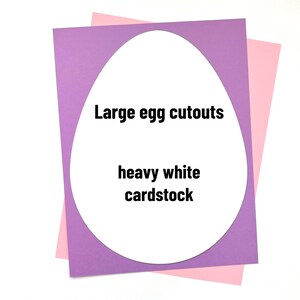 May include: Two pieces of cardstock, one purple and one pink, with a large white egg cutout in the center. The cutout has the text "Large egg cutouts" and "heavy white cardstock" written on it.