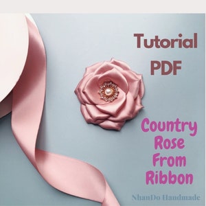 May include: A tutorial PDF for making a country rose from ribbon. The image shows a pink satin ribbon and a pink satin rose with a pearl and rhinestone embellishment. The text "Tutorial PDF Country Rose From Ribbon" is visible in the image.