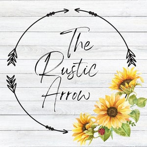 May include: A rustic wood background with a black circle and arrows. The text "The Rustic Arrow" is written in black cursive inside the circle.  Three yellow sunflowers with green leaves are arranged around the circle.