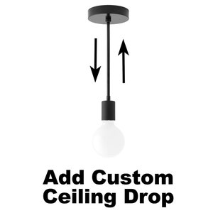 May include: Black pendant light with a white bulb. The light fixture has a black cord and a round canopy. The image shows that the cord length can be adjusted. The text "Add Custom Ceiling Drop" is below the light.