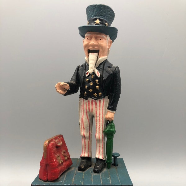 Vintage cast iron Uncle Sam moving parts coin bank.