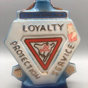 Vintage ceramic Jim Beam Feet Resue Association commemorative decanter.