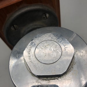 May include: Close-up of a silver metal valve with the text "SLOAN VALVE CO. U.S.A." and "ROYAL" printed on the top.
