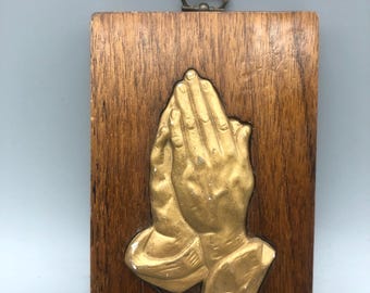 Vintage praying hands wall decor.