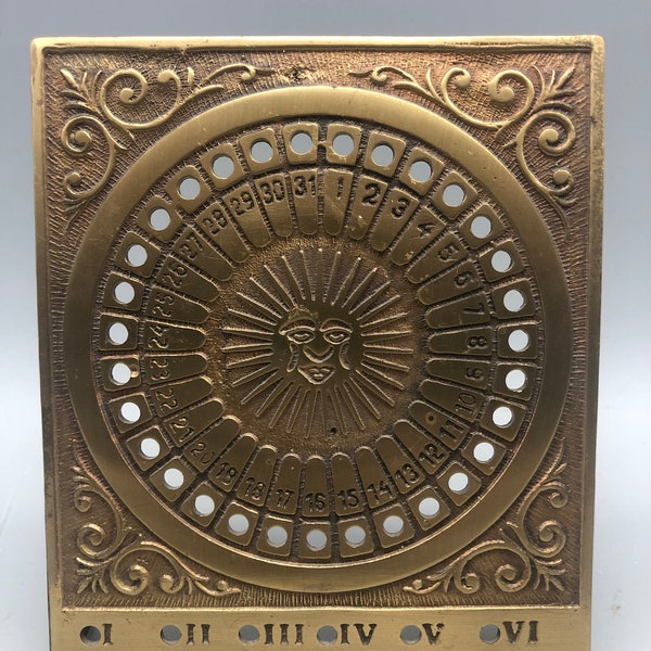 Vintage brass annual Sol calendar.