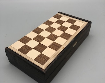 Vintage fold up travel chess set with original plastic pieces.