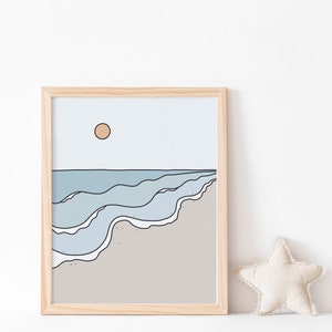 May include: A framed illustration of a beach scene with blue waves and a light brown sandy shore. The sun is a light orange circle in the sky.