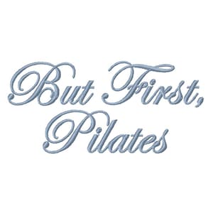 May include: Pale blue cursive text on a white background reads "But First, Pilates." The text is in a decorative, elegant font, suggesting a focus on fitness and wellness. The design is simple and clean.