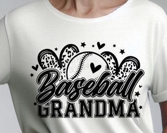 May include: White t-shirt with a black graphic that says "Baseball Grandma." The design includes a baseball, hearts, and stars. The shirt is a crew neck with short sleeves.