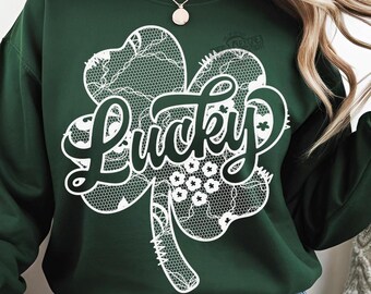 May include: A green sweatshirt with a white lace design of a four-leaf clover with the word "Lucky" in the center.