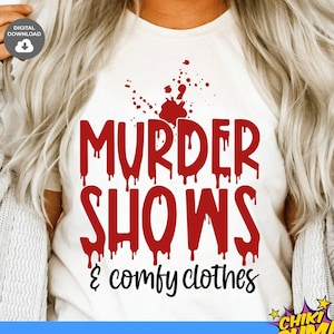 May include: Red text on a white t-shirt that reads "MURDER SHOWS & comfy clothes". The text is dripping with blood-like red drops. The design is perfect for fans of true crime and murder mystery shows.