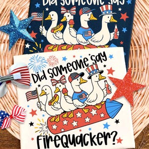 May include: Two patriotic-themed designs featuring cartoon ducks. One design is on a navy background, the other on white, both with the text "Did someone say." The white design includes the text "Firequacker?" and ducks with hot dogs, ice cream, and drinks.