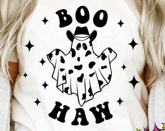 May include: A white t-shirt with a black and white ghost wearing a cowboy hat and the text "BOO HAW" in a retro font. The ghost is patterned with cow spots.