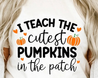 May include: White t-shirt with the text "I TEACH THE cutest PUMPKINS in the patch" in black, orange, and white. The design includes orange pumpkins and hearts. The bottom of the image has the text "SVG + DXF + EPS + PNG + JPG".