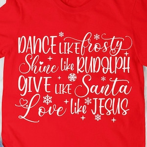 May include: Red t-shirt with white text that reads "Dance like Frosty, Shine like Rudolph, Give like Santa, Love like Jesus".
