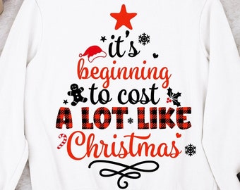 May include: White sweatshirt with a red and black buffalo plaid Christmas tree design. The text on the tree reads "it's beginning to cost a lot like Christmas".
