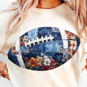 May include: A cream-coloured t-shirt with a football design. The football is a patchwork of denim and floral patterns in blue, red, orange, and white. The shirt also has the text "ONLY PNG 300 DPI".