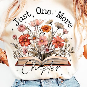 May include: White t-shirt with the text "Just One More Chapter" and a floral design with a book underneath the text.