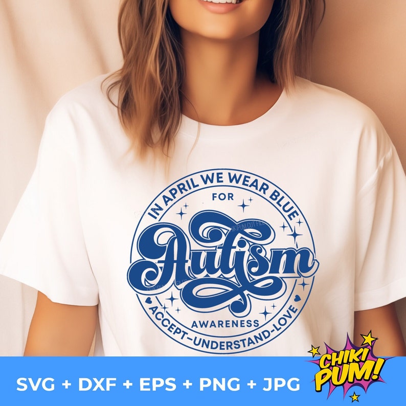 May include: A white t-shirt with a blue circle design that says "In April We Wear Blue For Autism" with the word "Autism" in a stylized font. The circle also includes the words "Awareness, Accept, Understand, Love".