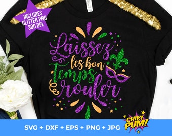 May include: A black t-shirt with a glittery purple, green, and gold design that says "Laissez les bon temps rouler". The design includes a fleur-de-lis and a mask. The shirt is surrounded by white flowers and a pair of jeans.