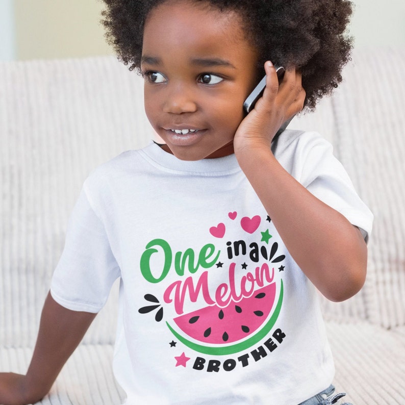 May include: A white t-shirt with a watermelon graphic and the text "One in a Melon Brother".