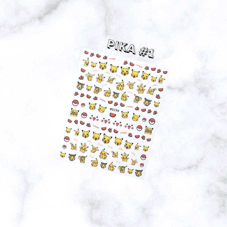 May include: A sheet of nail art stickers featuring various yellow Pikachu designs, red watermelon slices, and Poke Balls. The sheet is labeled "PIKA #1" in black and white text. The stickers are on a white background.