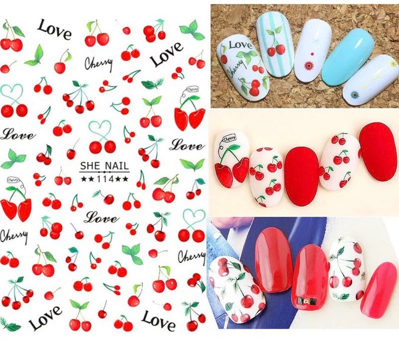 May include: A sheet of nail art stickers featuring red cherries, green leaves, and the word "Love" in black. Several nail designs with cherry patterns are also shown, including solid red and white nails with cherry decals.