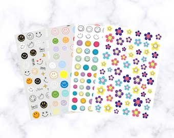 May include: Four sheets of stickers with various designs. One sheet features smiley faces in different colors, another has smiley faces and text like "Cute" and "Okay". The other two sheets have smiley face flowers.