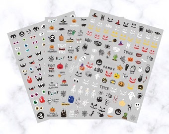 May include: Four sheets of Halloween-themed nail art stickers. Designs include jack-o'-lantern faces, ghosts, spiders, bats, and the words "BOO!", "TREAT", and "CANDY". The stickers are in black, orange, white, and green on a gray background.