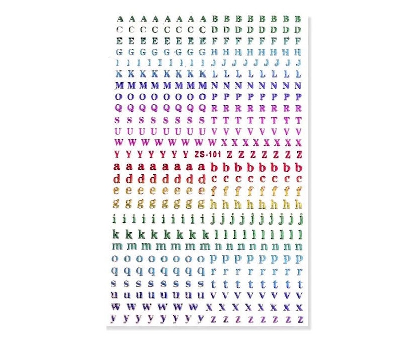 May include: A sheet of alphabet stickers in various colors, including purple, blue, and gold. The stickers feature both uppercase and lowercase letters, with the text "ZS-101" visible. The letters are arranged in neat rows and columns.