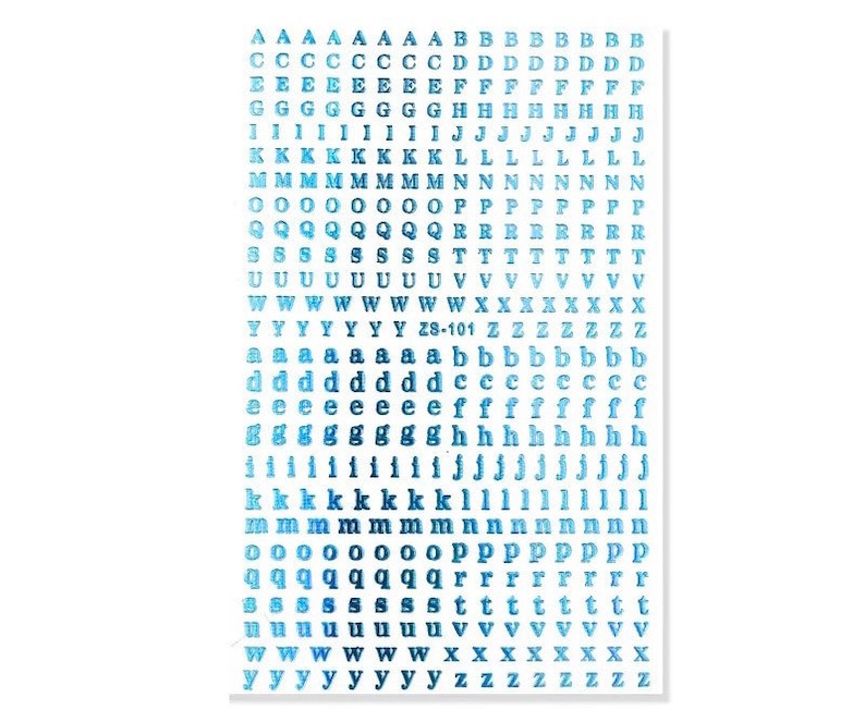 May include: A sheet of blue and white alphabet stickers. The stickers include uppercase and lowercase letters, with a variety of fonts. The text "ZS-101" is printed on the sheet. The stickers are arranged in rows and columns.